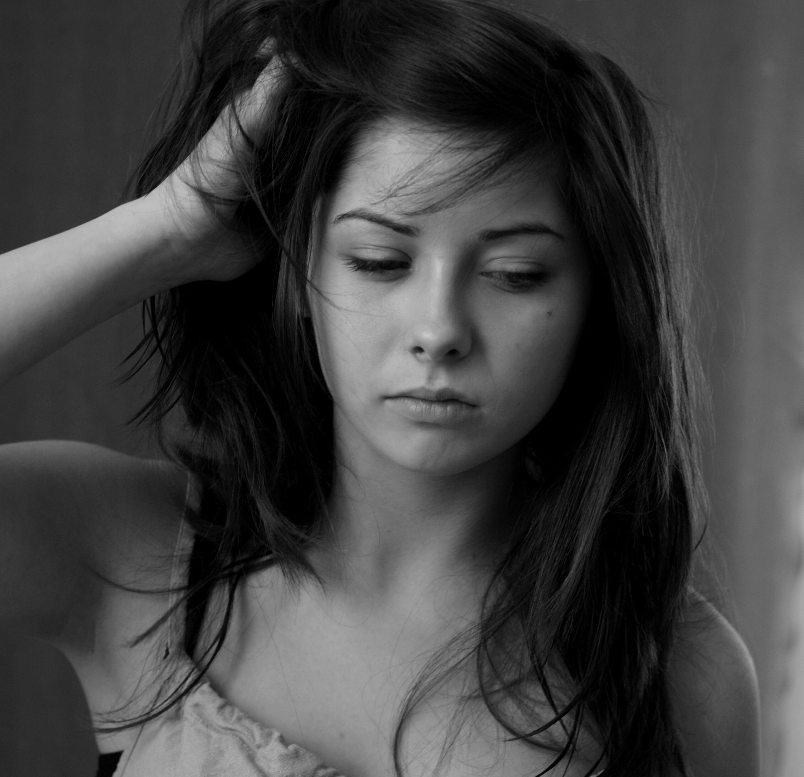 A woman with long hair is looking at the camera
